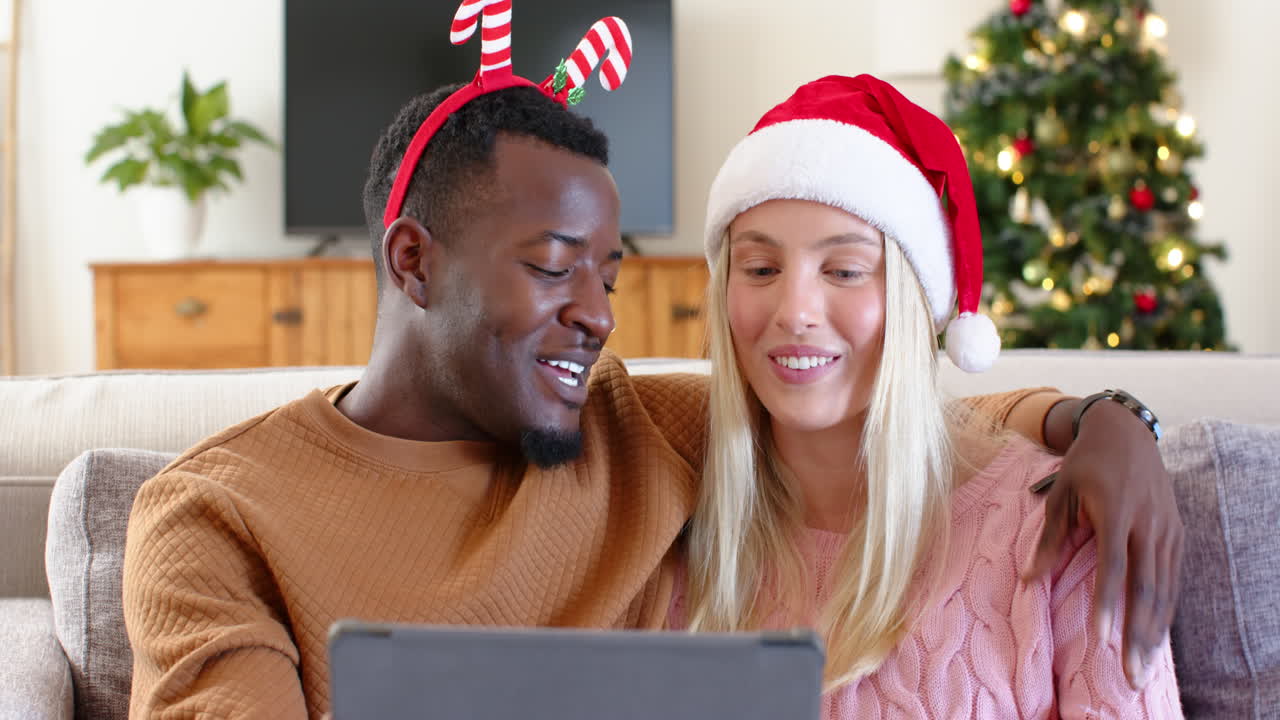 Shopping online with credit card, African American man and woman celebrating Christmas