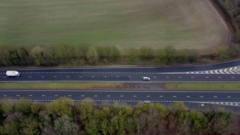 the a2 dual carriage way lined with trees and green open fields towards dover