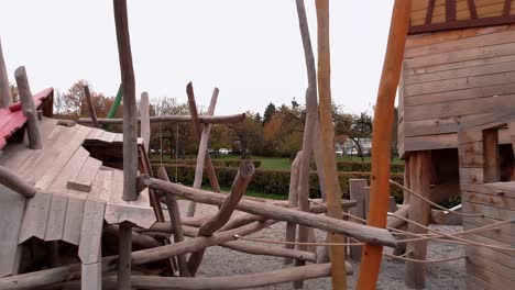 drone flies forward low and smoothly through the playground, passing very close to the play equipment