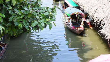 colorful boats move through a bustling waterway