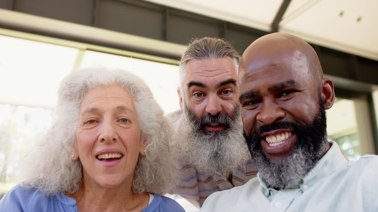 Senior friends looking surprised and excited, enjoying time together indoors