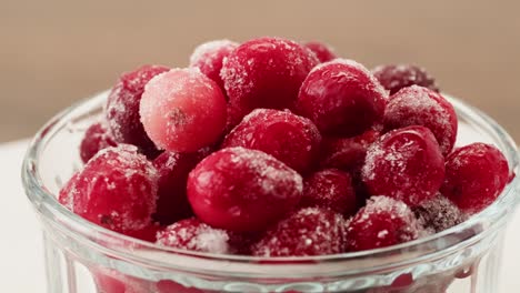 frozen cranberries in snow for tea, background close up of cranberry berries in winter park, ice fridge macro.