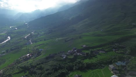 drone performs a semi orbit around a bright rice terrace catching sunlight on the water. lao cai, sa pa
