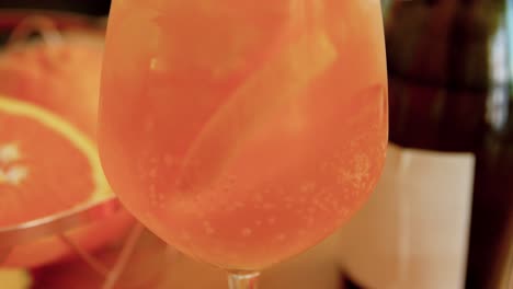 Woman-Making-Cocktail-Drink-at-Home-Kitchen.drinks-and-people-concept--happy-smiling-young-woman-making-orange-cocktail-at-home-kitchen