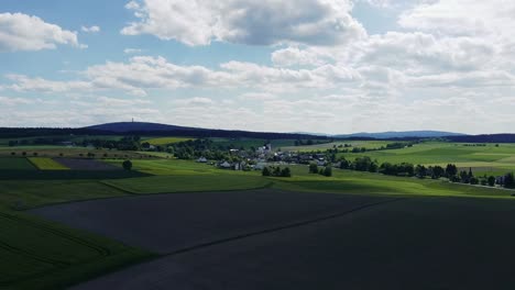 scenic footage captures vast agricultural landscape stretching beneath cloudy sky in england, uk. the patchwork of cultivated fields extends to horizon creating peaceful rural scene