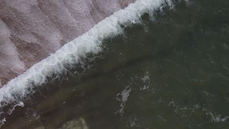 Close-up-drone-shot-of-the-water-pouring-over-the-Asprokremmos-Dam-as-it-overflows