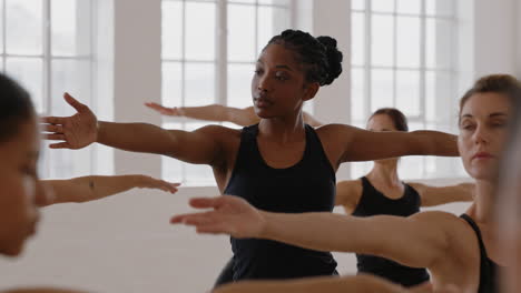 yoga woman instructor teaching reverse warrior pose meditation with group of multiracial women enjoying healthy lifestyle exercising in fitness studio at sunrise