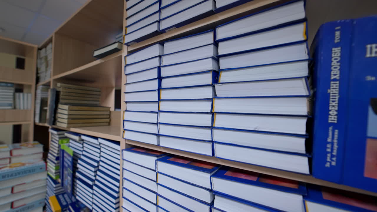 Passing row of books. Bookshelves in university library with lots of books