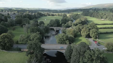 An-aerial-view-of-the-Devil's-Bridge-at-Kirkby-Lonsdale-on-a-summer-evening,-Yorkshire,-England,-UK