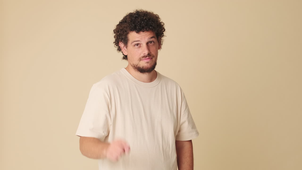 Man with curly hair gesturing