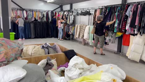 a group of people in second hand used clothing sale a group of people in second hand used clothing sale