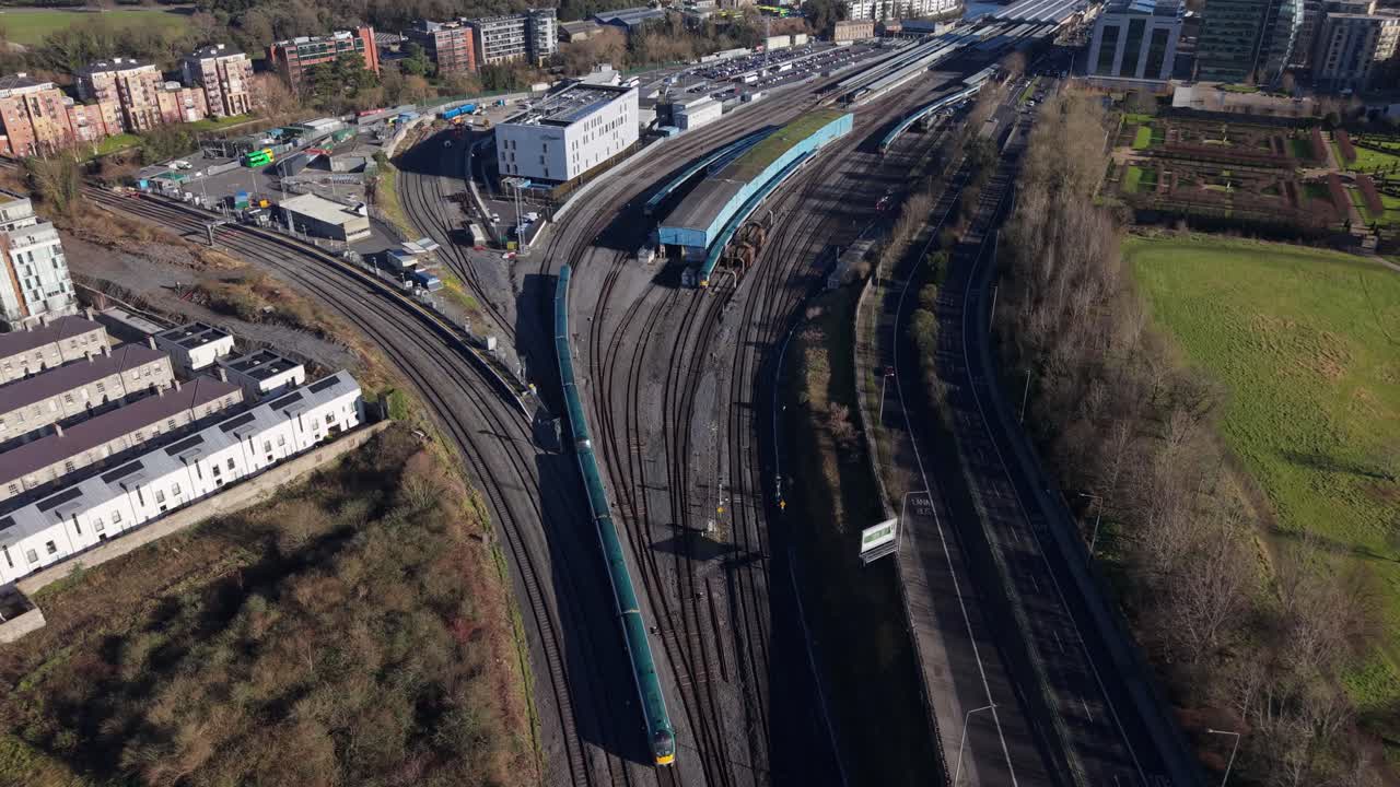 Dublin train station aerial, railway tracks, urban buildings, and green park view