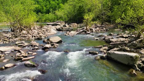 aerial view of narrow rapids with boulders along river, west virginia