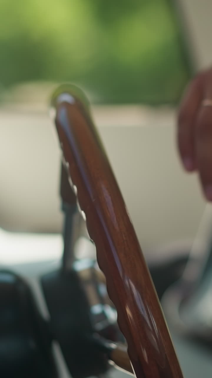 Skipper puts hand on luxury yacht with helm in pilothouse closeup. Yachtsman starts motor boat voyage on sunny day. Young man takes steering wheel