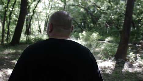 a man walking through forest trees