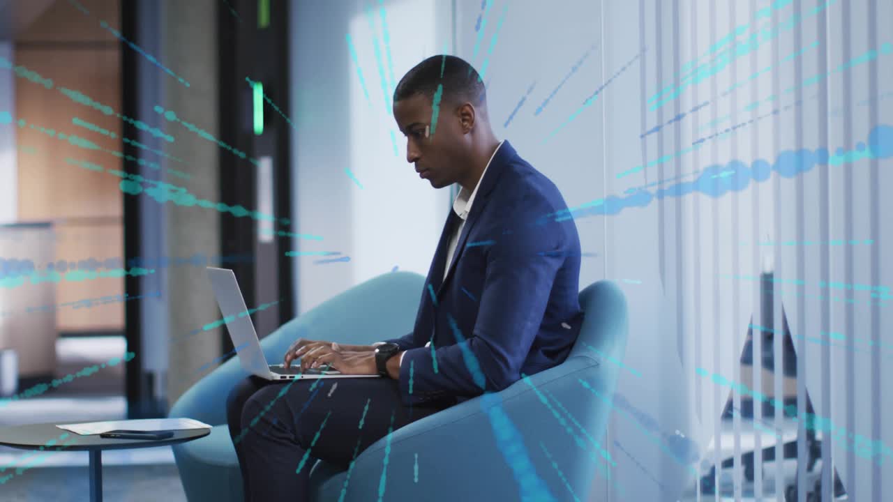 Businessman typing on laptop in corporate lounge, activating blue data lines for analytics