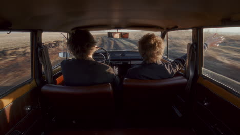 couple driving down empty rural road and having conversation