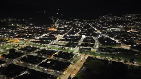 stunning aerial view of zipaquira at night, showcasing the city's twinkling lights and grid pattern streets under a clear night sky. captured with a drone, enhancing the vibrant urban panorama