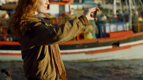 woman clicking photos with mobile phone at dock 4k