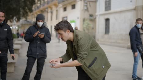 street magician performing a card trick