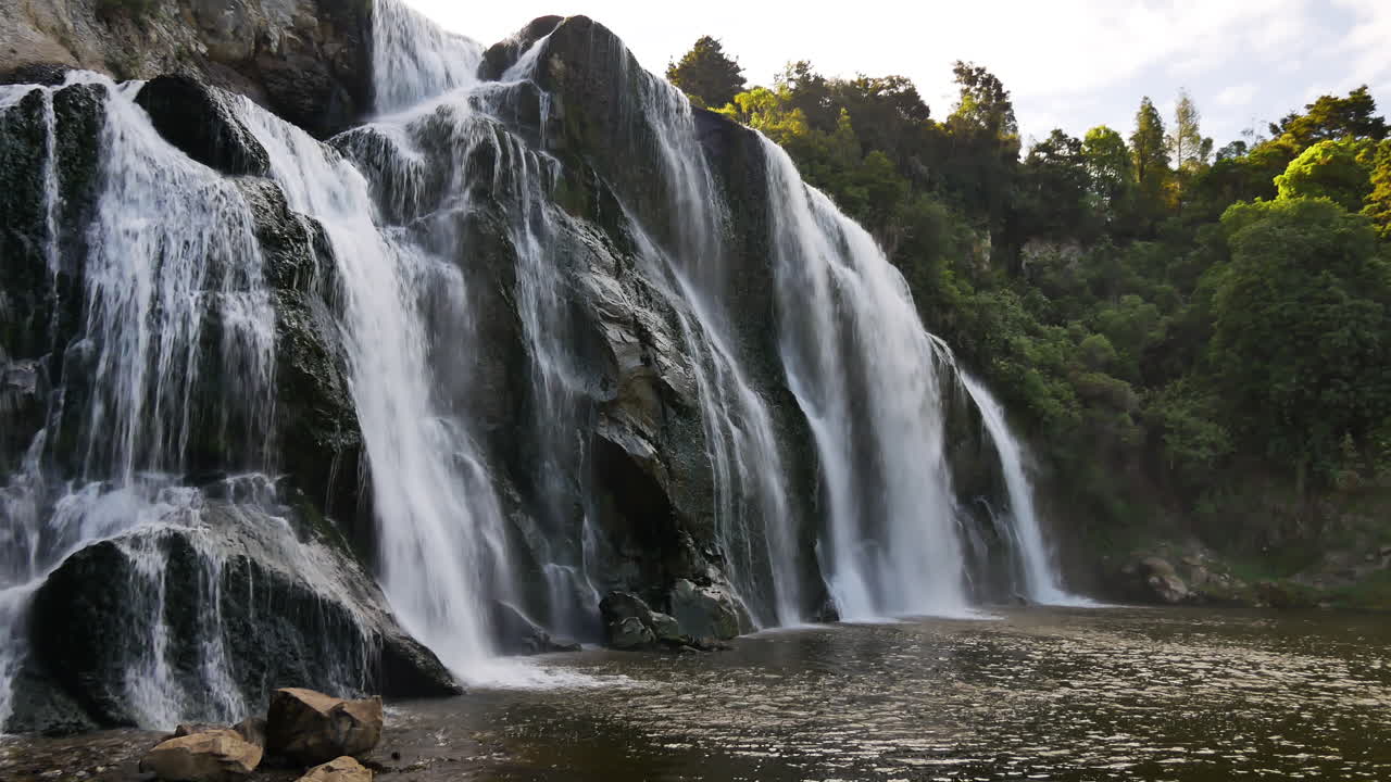 toma panorámica de las cataratas waihi gigantes que se estrellan contra las rocas rodeadas de una hermosa naturaleza en la reserva escénica de la isla norte de nueva zelanda