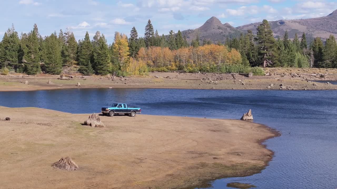 Serene lake view at Scotts-Lake Tahoe with parked truck, calm and peaceful