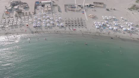 Reyna-Beach-With-Tourists-And-Parasols-At-The-Black-Sea-Resort-In-Constanța,-Romania