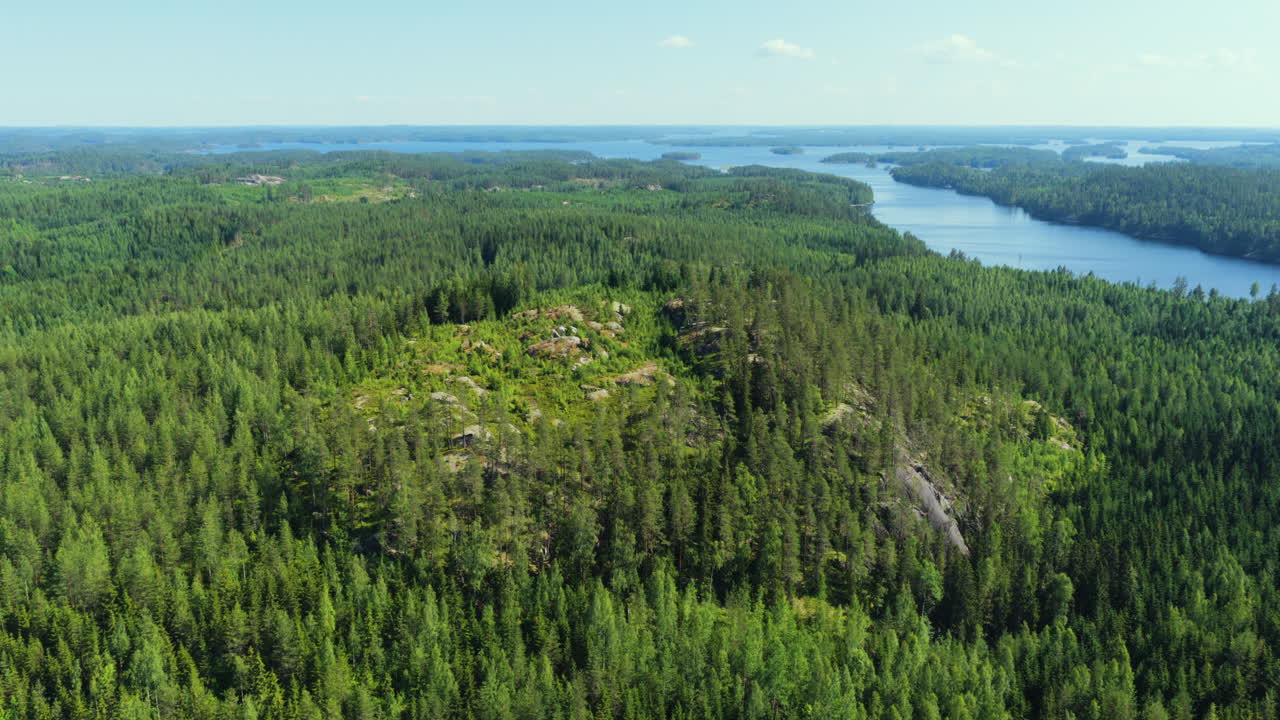 Aerial view circling the Iivuori mountain, sunny, summer day in Sulkava,, Finland