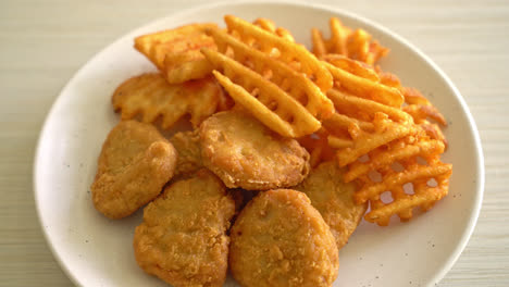 fried chicken nuggets with fried potatoes