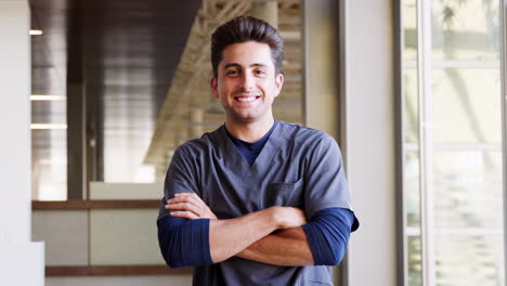 young hispanic male doctor wearing scrubs