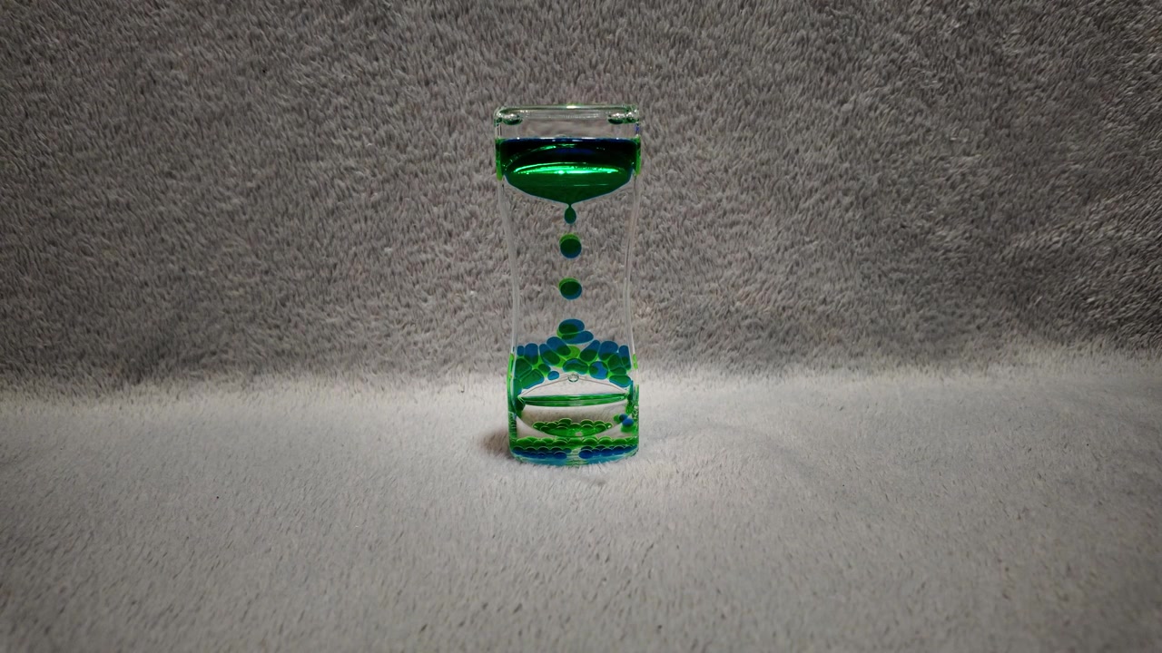Colorful liquid hourglass with flowing bubbles
