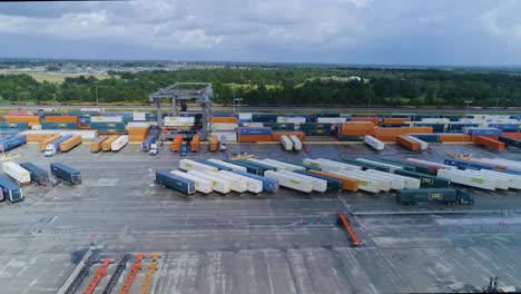 4k drone video of trains and trucks at csx intermodal train yard in winter haven, fl