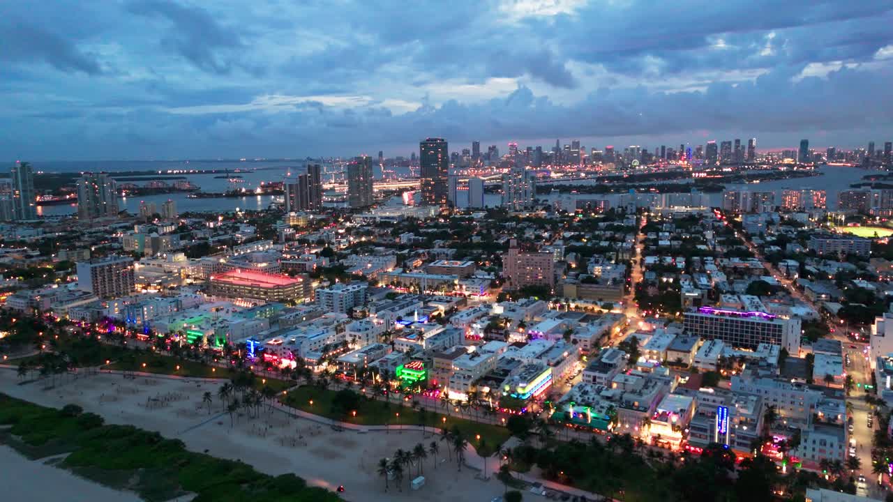 Drone shot of Miami Beach at dusk with neon lights