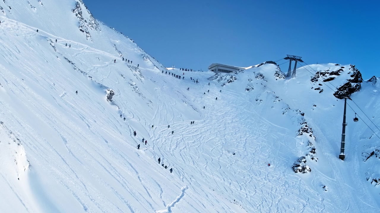 Timelapse of the famous Tortin sector in Verbier as the lifts open after fresh snowfall. Hundreds of skiers fan out across untouched powder, carving fresh tracks down the mountain.