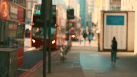 City-morning,-line-of-red-buses-in-street-busy