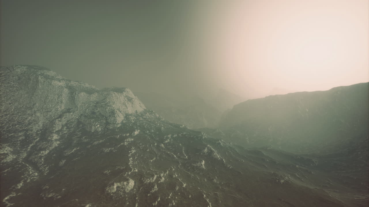 Mysterious landscape with fog and light illuminating distant mountains
