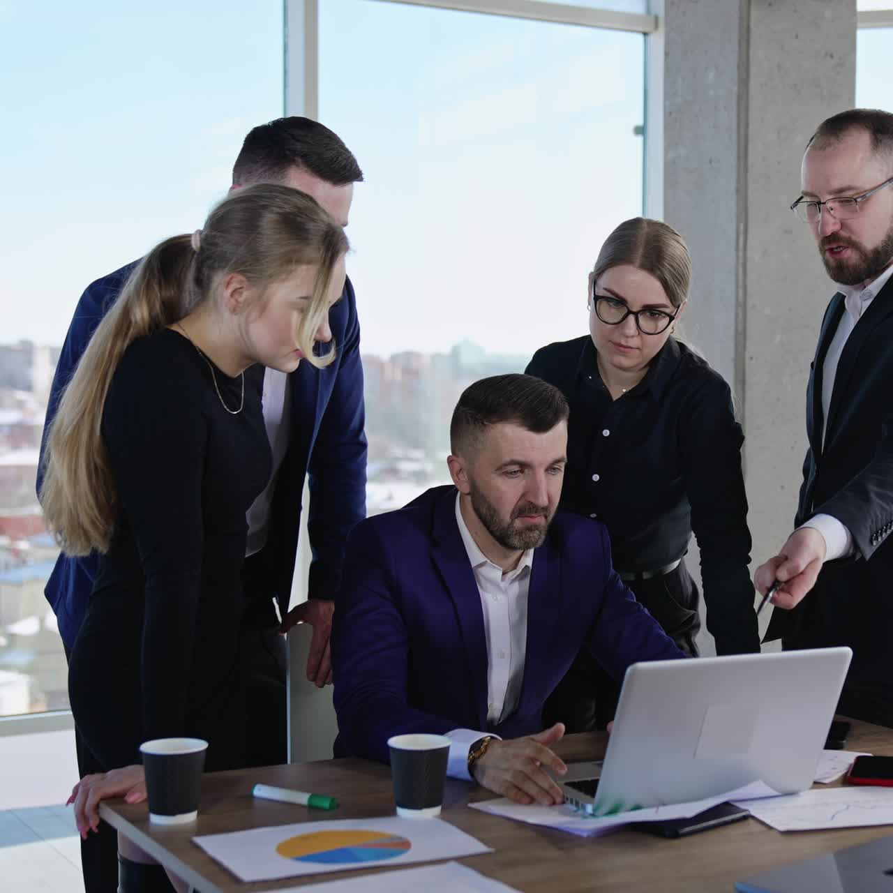 Collaboration and teamwork in the office atmosphere. People proposing and discussing ideas looking at laptop. Cityscape at backdrop
