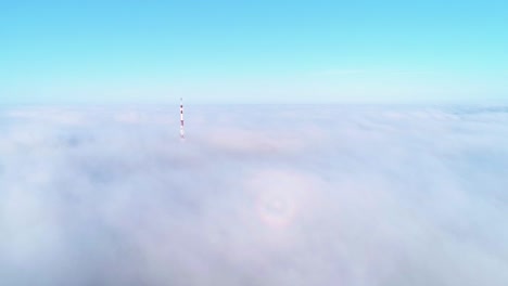 flight over misty clouds in morning sunlight with little glory and city scape under clouds