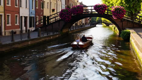 couple enjoying a boat ride on a canal in europe