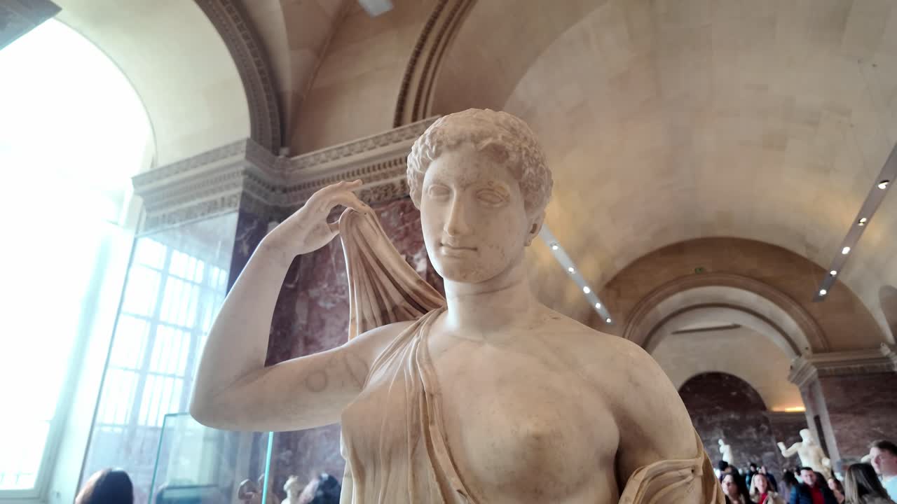 close up face venus genitrix. Roman white marble sculpture of a woman goddess holding clothes with her hand.