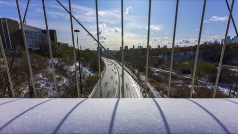 Timelapse-over-the-busy-Don-Valley-Parkway-from-the-Bloor-Street-Viaduct-in-Toronto-on-a-crisp,-snowy-Canada-Day