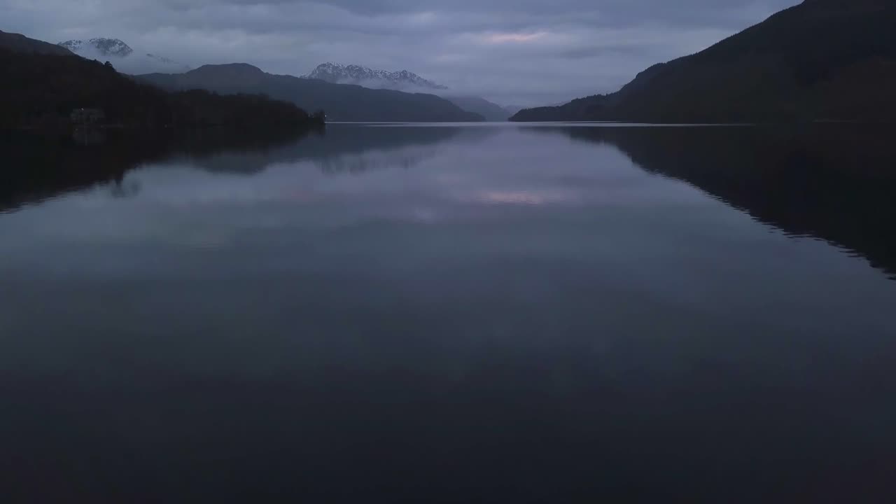 A flight over a lake at sunset in Scotland
