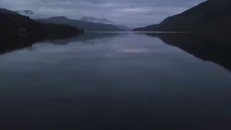 A-flight-over-a-lake-at-sunset-in-Scotland