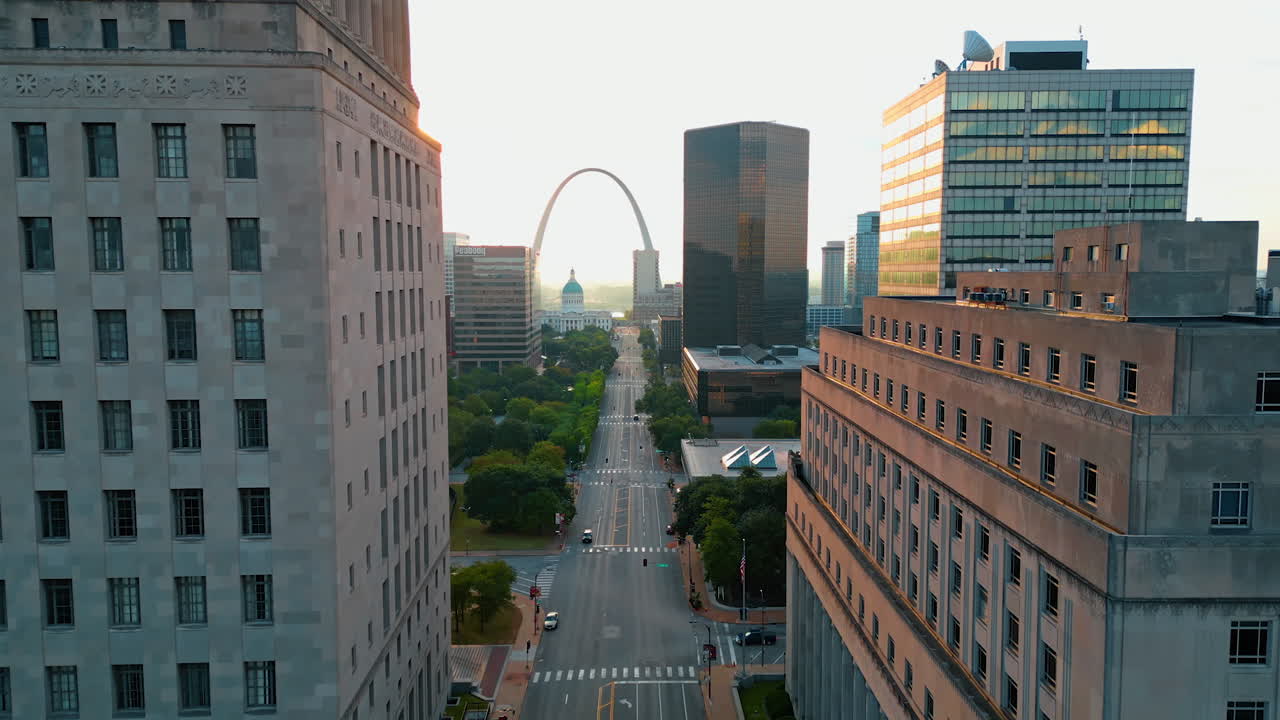 Saint Louis USA, 14 August 2025: Flying over the wide empty street of St. Louis, Missouri, USA at sunset. Approaching the Gateway Arch at backdrop