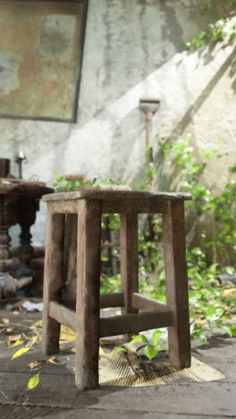 a wooden stool in an abandoned room