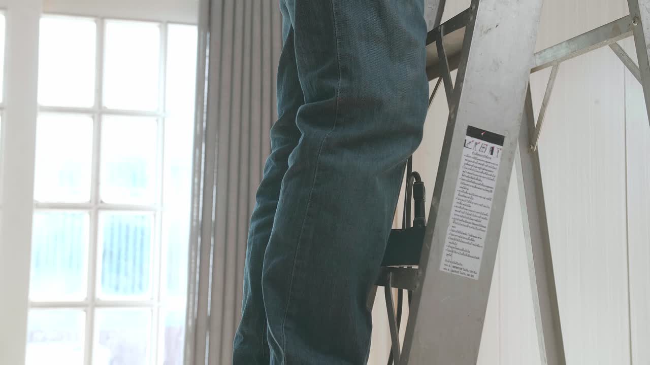 Asian Man Use Electric Drill To Drilling The Wall, Home Improvement And Repairs