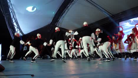 men dancers from kosovo performing on stage of folk festival in tirana, albania