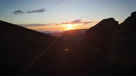 couple, walking trail during sunset in madeira, golden hour in high altitude mountains