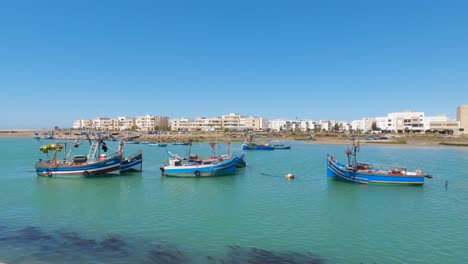 traditional boats anchored along the coast and docked on river bou regreg, rabat, morocco