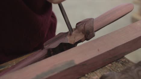 closeup on a woodcarver tool used to sculpt a piece of timber